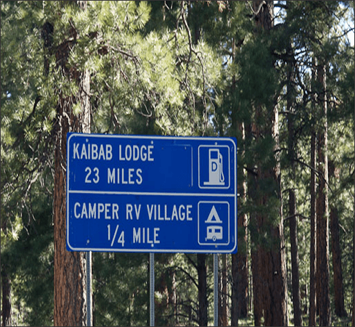 Highway sign showing Kaibab Camper Village 1/4 mile ahead and Kaibab Lodge 23 miles ahead